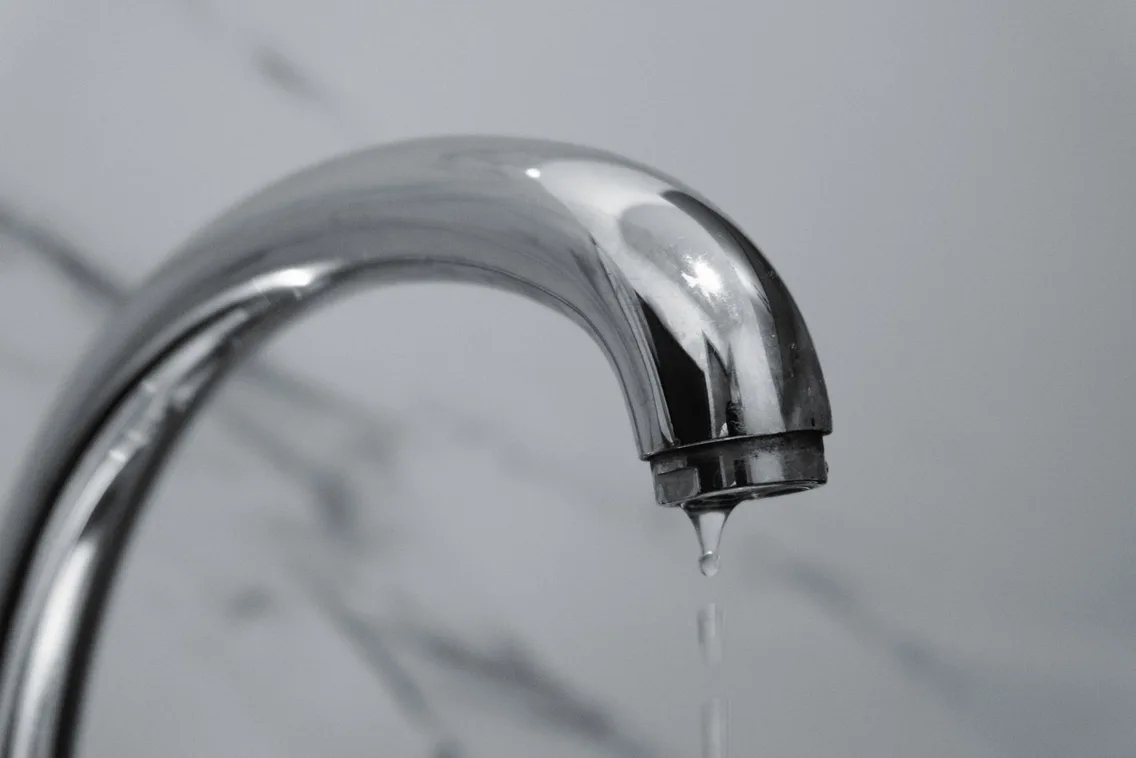 Water dripping from a chrome bathroom tap