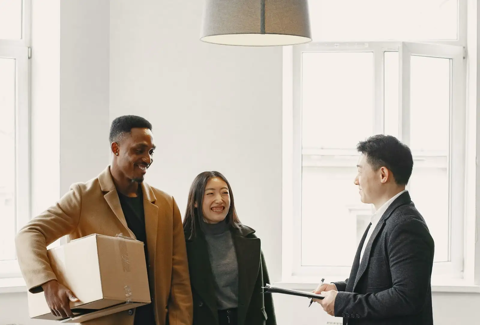 An owner showing a flat to a couple interested in renting it